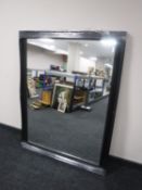 A black framed overmantel mirror