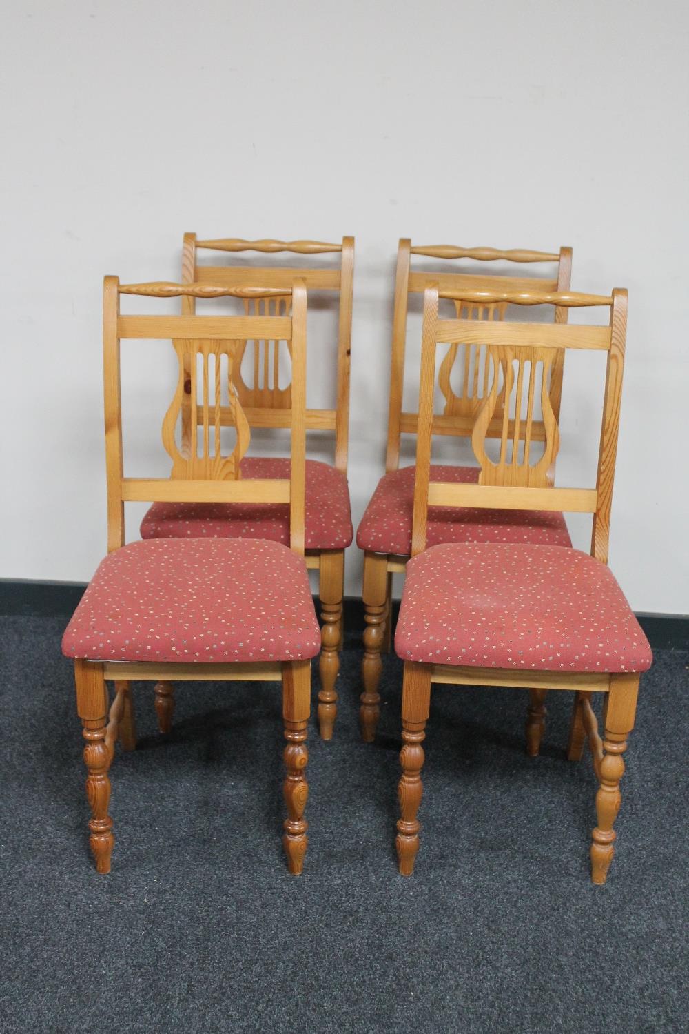 A set of four contemporary pine dining chairs