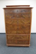 A continental mahogany and walnut seven drawer chest