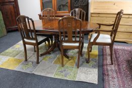 A reproduction inlaid mahogany dining table and five chairs