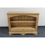 A pine open bookshelf fitted two drawers