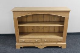 A pine open bookshelf fitted two drawers