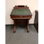 A Victorian mahogany Davenport, width 61 cm, with glass inkwells.