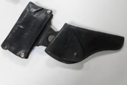 A good quality leather pistol holster with ammunition cover