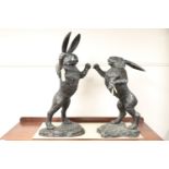 A pair of bronze figures - boxing hares,