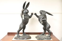A pair of bronze figures - boxing hares,
