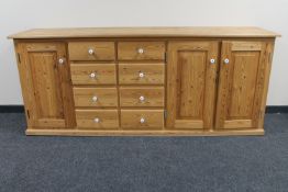 A pine dresser fitted cupboards and drawers beneath