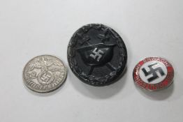 A Third Reich wound badge together with post-war badge and coin.