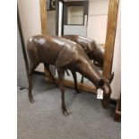 A cast patinated aluminium figure - a doe grazing,