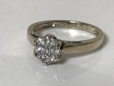 An 18ct gold diamond cluster ring size M, approximately 0.25ct.