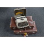 Two vintage leather suitcases and a Triumph typewriter
