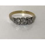 An 18ct gold diamond three stone ring, size L, approximately 0.33ct.