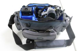 A camera bag containing Pentax MX camera with various lenses etc