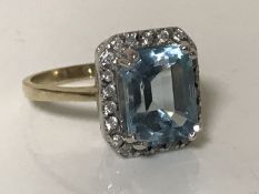 A blue topaz and diamond ring