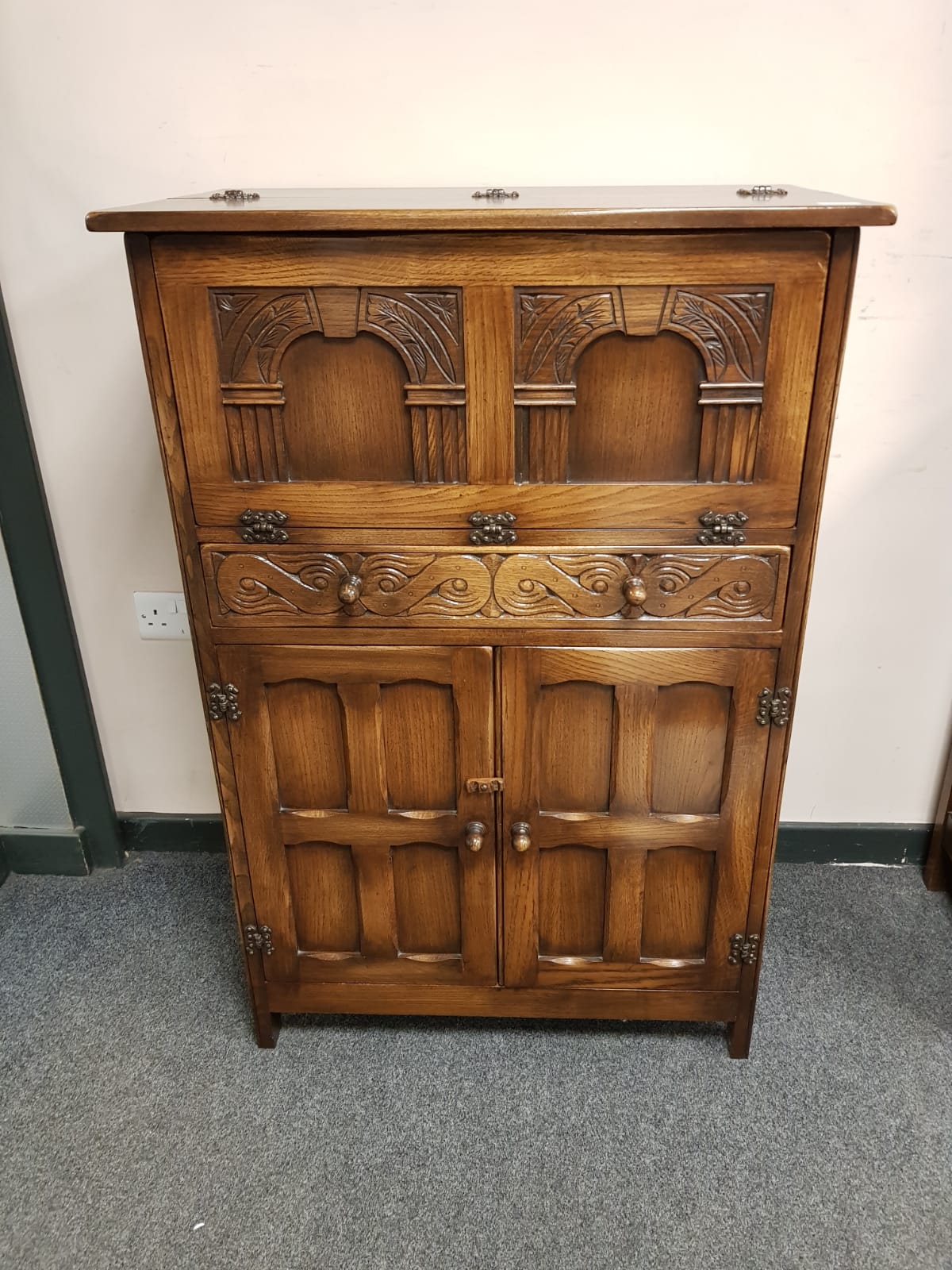 A Reprodux oak cocktail cabinet,