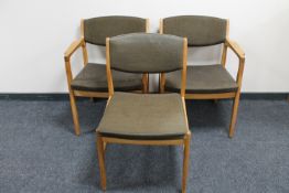 A pair of continental blond oak armchairs together with a matching single chair