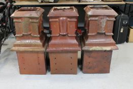 A set of three antique glazed chimney pots