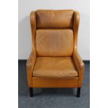 A mid 20th century Danish tan leather wingback armchair in the manner of Borge Mogensen