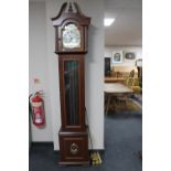 A contemporary Tempus Fugit longcase clock with pendulum and weights