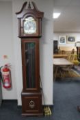 A contemporary Tempus Fugit longcase clock with pendulum and weights