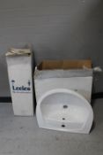 A boxed ceramic wash basin and pedestal