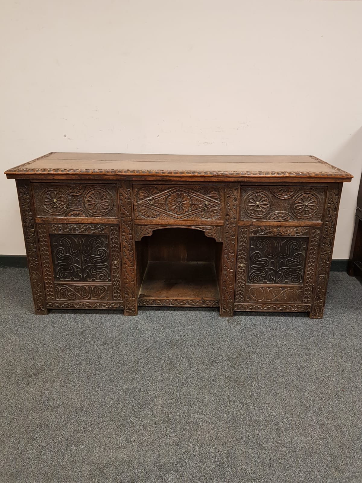 A Victorian carved oak sideboard,