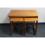 A teak foldover top table fitted two beneath