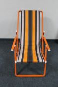 A folding metal deck chair