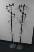 A pair of wrought metal candle holders