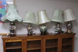 A group of five earthenware table lamps with shades