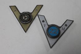 Two vintage car badges