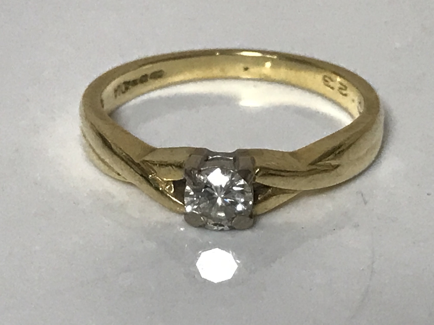 An 18ct gold diamond solitaire ring, approximately 0.2ct, size N 1/2.