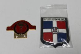 A Domincan Republic car badge and a Calgary Vintage Auto Club car badge