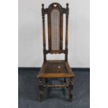 A carved oak high back hall chair