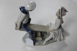 A Lladro figure of children on a seesaw, height 24 cm.