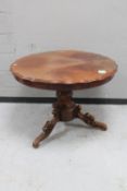 A 19th century mahogany scalloped edge dining table on carved tripod base