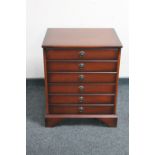 A mahogany effect six drawer chest