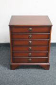 A mahogany effect six drawer chest