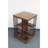 A late Victorian inlaid mahogany book table raised on castors