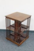 A late Victorian inlaid mahogany book table raised on castors