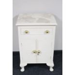 A white painted cabinet fitted a drawer