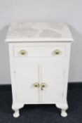 A white painted cabinet fitted a drawer