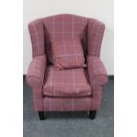 A wingback armchair in checkered purple upholstery