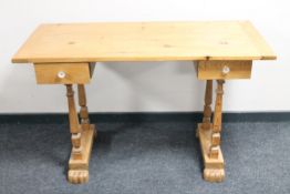 A pine writing table fitted two drawers
