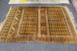 An Afghan Bokhara rug on gold ground,