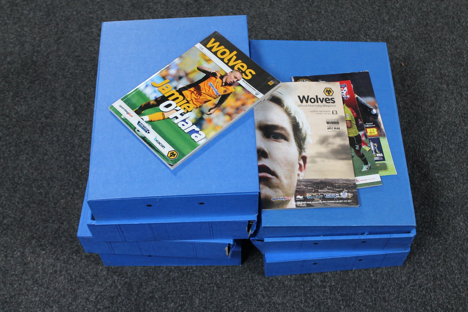 Seven folders containing a large quantity of football programmes