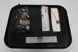 A box containing silver locket, crowns,