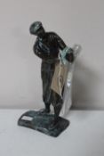 A bronze figure of a golfer (club loose)