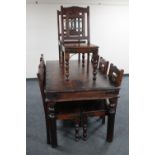 A hardwood dining table and matching set of eight chairs