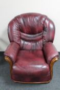 A wood framed Burgundy leather armchair